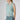Side view of Bella Cashmere Top Dew highlighting structured fit and delicate cable knit pattern.