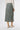 Back view of konbu green suede midi skirt highlighting minimal design and comfortable elastic waist