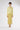 Model wearing Lemu yellow suede midi skirt with elastic waist, front view