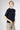 Side profile of the Magda Cashmere Pullover Beluga revealing its flattering fit and elegant lightweight drape.