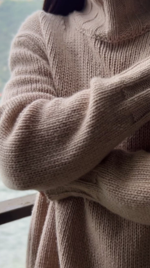 Model wearing Basilia Cashmere Turtleneck in Feather, showing fit and elegant drape